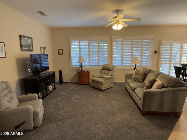 carpeted living room featuring ceiling fan