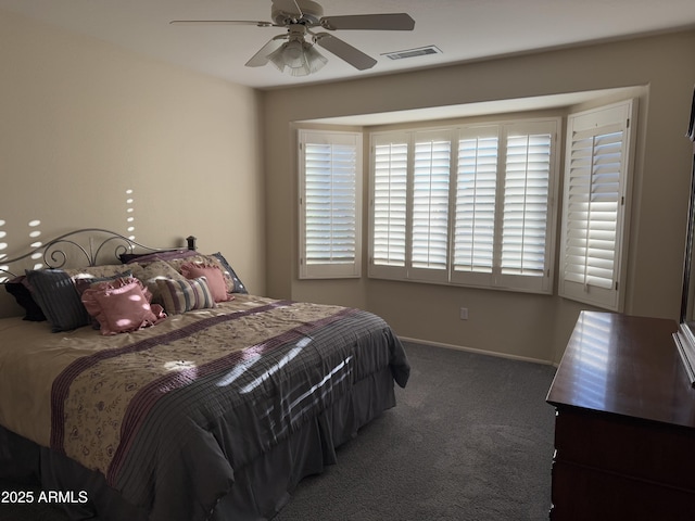 bedroom featuring ceiling fan and dark colored carpet