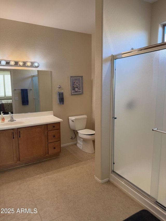 bathroom featuring vanity, toilet, and an enclosed shower