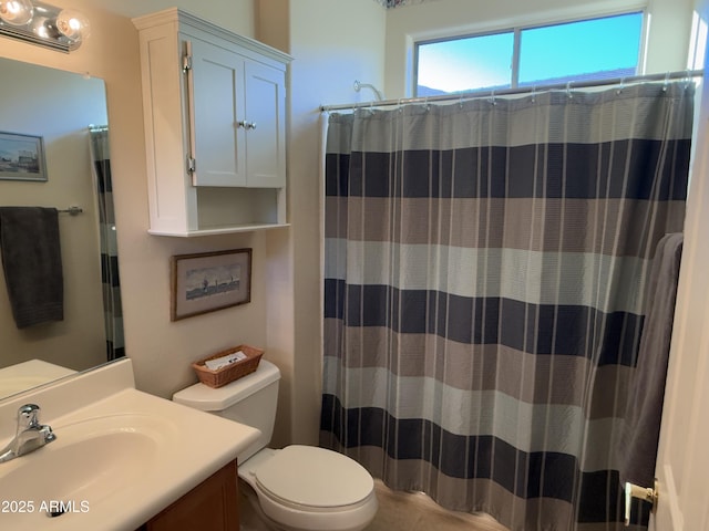 bathroom with vanity, toilet, and curtained shower