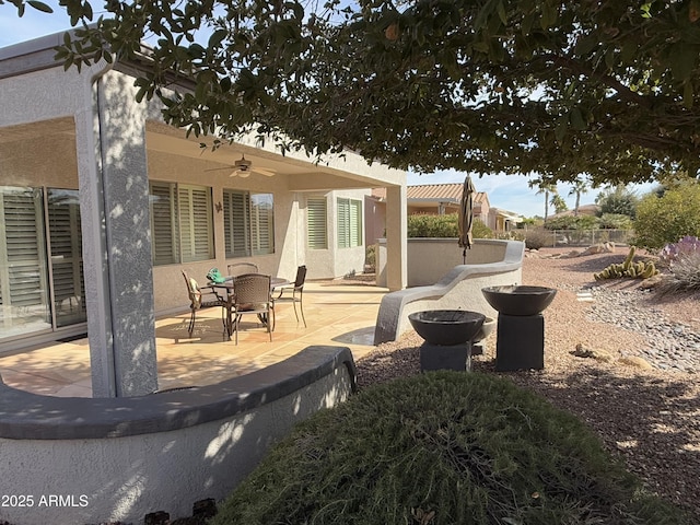 view of yard with ceiling fan and a patio area