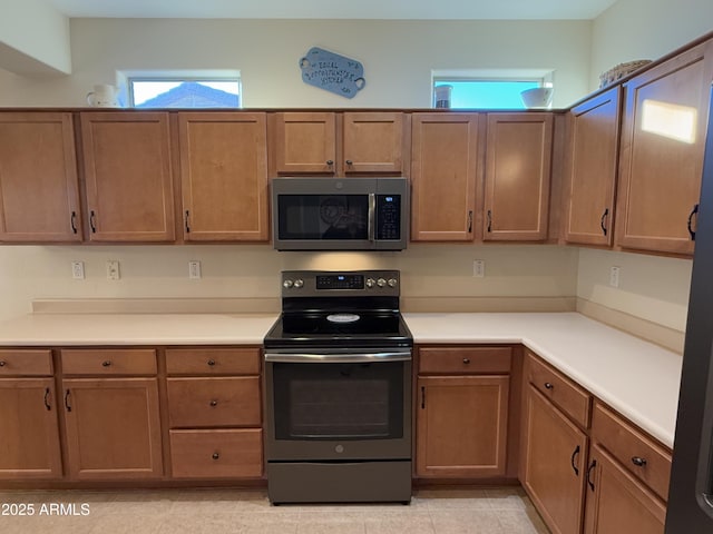 kitchen featuring light tile patterned floors and black / electric stove