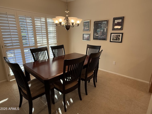 dining space featuring a notable chandelier and light tile patterned flooring