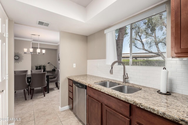 kitchen with a sink, light stone countertops, dishwasher, light tile patterned floors, and visible vents