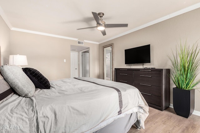 bedroom with crown molding, light wood-type flooring, baseboards, visible vents, and ceiling fan