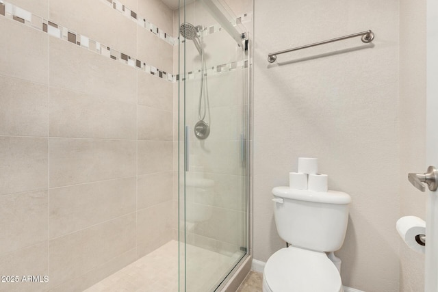bathroom with toilet and a stall shower