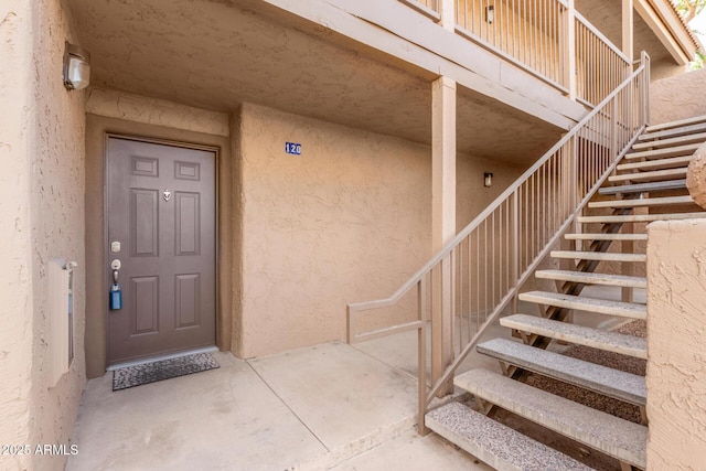 property entrance featuring stucco siding