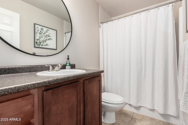 bathroom featuring tile patterned flooring, vanity, and toilet
