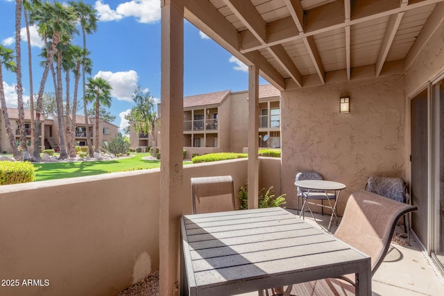 balcony featuring a residential view and outdoor dining area