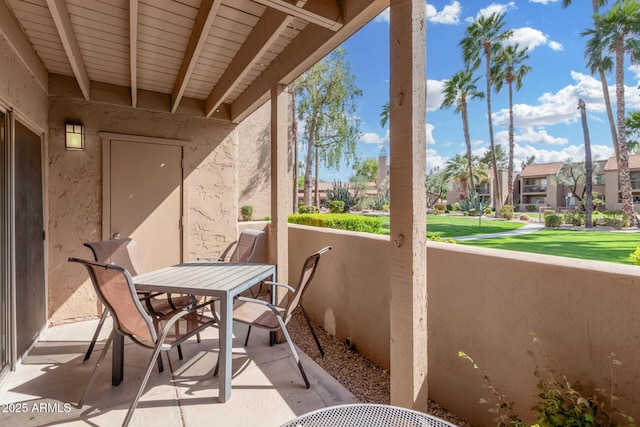 view of patio with a balcony, a residential view, and outdoor dining area