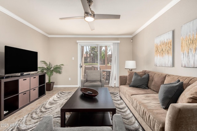 living area with baseboards, ceiling fan, and crown molding