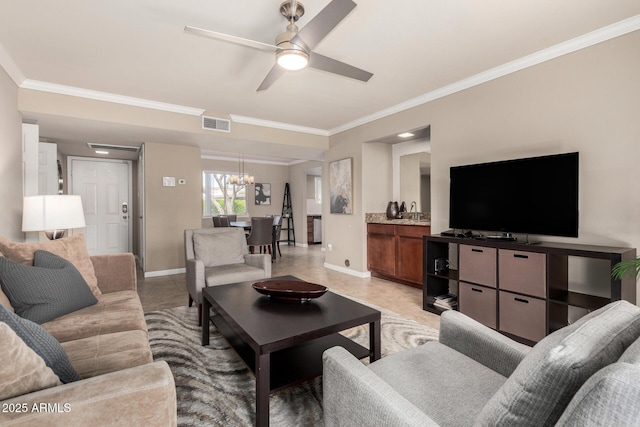 living room featuring baseboards, crown molding, visible vents, and ceiling fan with notable chandelier