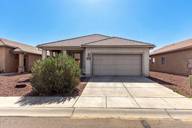 34516 S Pioneer Way, Red Rock, AZ 85145 - view of front facade with a tile roof, a garage, driveway, and stucco siding