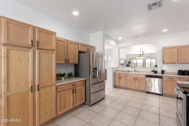 34516 S Pioneer Way, Red Rock, AZ 85145 - kitchen featuring stainless steel appliances, light countertops, light tile patterned flooring, a sink, and recessed lighting