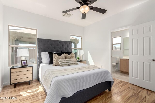 34516 S Pioneer Way, Red Rock, AZ 85145 - bedroom with light wood-style floors, ensuite bathroom, and a ceiling fan