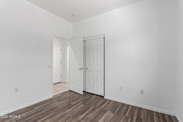 34516 S Pioneer Way, Red Rock, AZ 85145 - unfurnished bedroom featuring wood finished floors, a closet, and baseboards