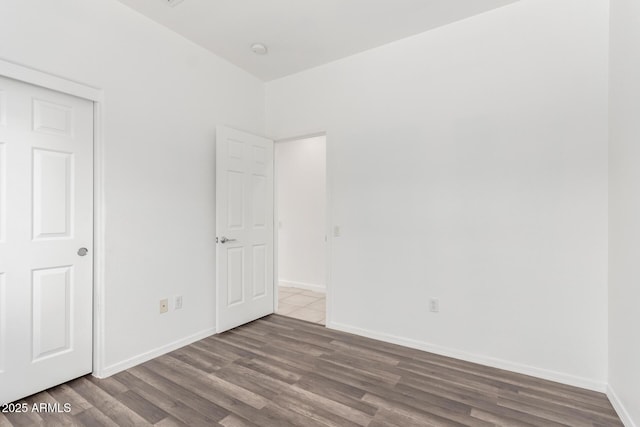 34516 S Pioneer Way, Red Rock, AZ 85145 - unfurnished bedroom featuring wood finished floors and baseboards