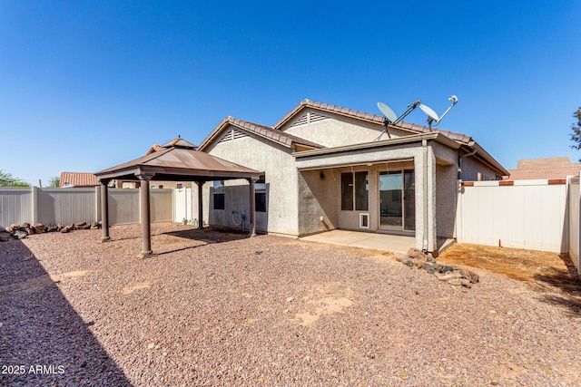 34516 S Pioneer Way, Red Rock, AZ 85145 - back of property featuring a gazebo, stucco siding, a fenced backyard, and a patio