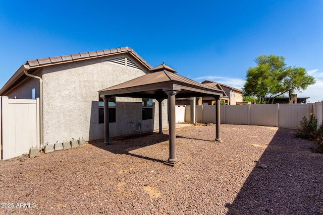 34516 S Pioneer Way, Red Rock, AZ 85145 - back of property featuring a gazebo, stucco siding, a fenced backyard, and a patio