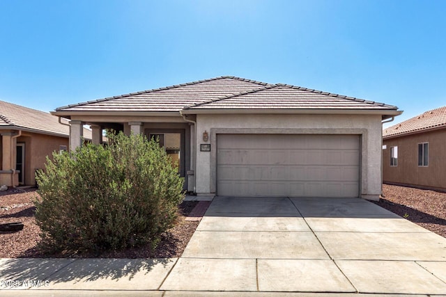 34516 S Pioneer Way, Red Rock, AZ 85145 - view of front of home featuring driveway, an attached garage, stucco siding, and a tiled roof