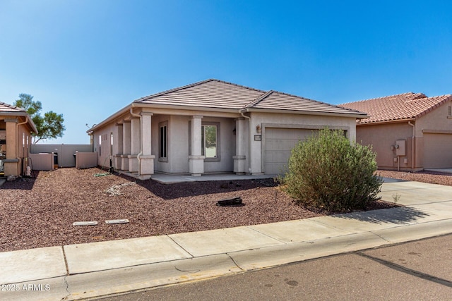 34516 S Pioneer Way, Red Rock, AZ 85145 - view of front facade featuring a garage, a tiled roof, driveway, and stucco siding