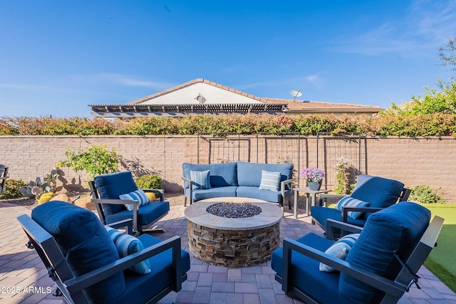 view of patio featuring an outdoor living space with a fire pit and a fenced backyard