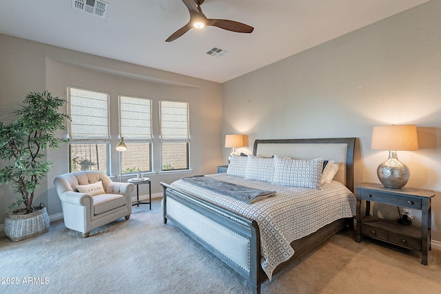 carpeted bedroom with visible vents, a ceiling fan, and baseboards