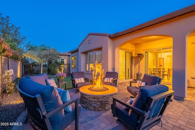 view of patio featuring an outdoor living space with a fire pit and fence