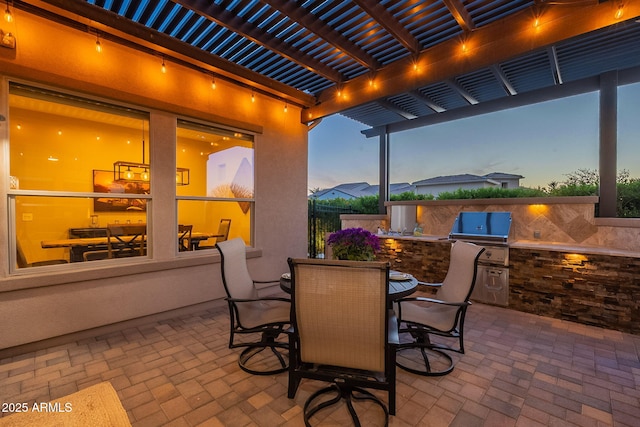 view of patio / terrace featuring outdoor dining space, an outdoor kitchen, a pergola, and a grill