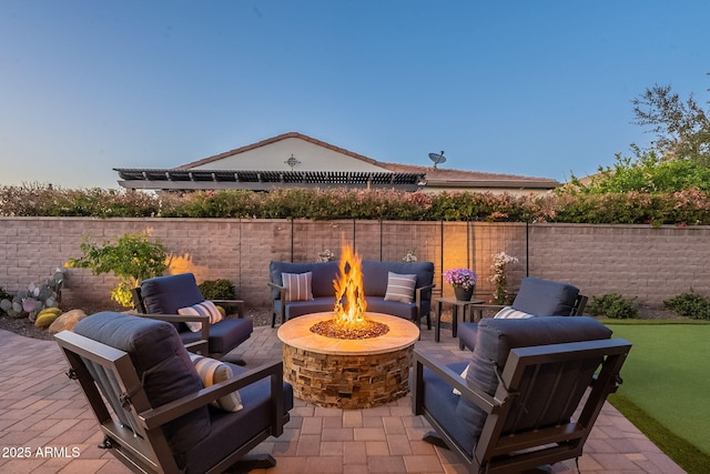 view of patio / terrace with an outdoor living space with a fire pit and a fenced backyard