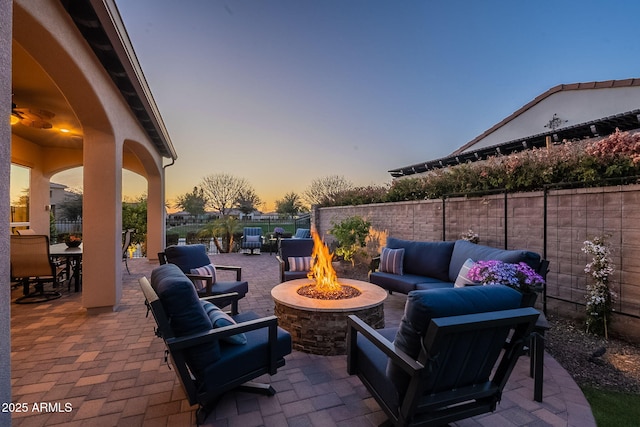 view of patio / terrace featuring an outdoor living space with a fire pit and a fenced backyard