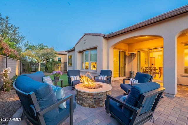 view of patio / terrace featuring an outdoor living space with a fire pit and fence