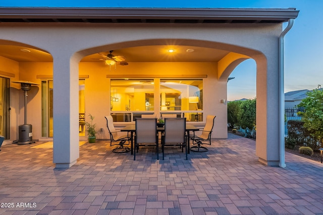 view of patio with outdoor dining space and fence