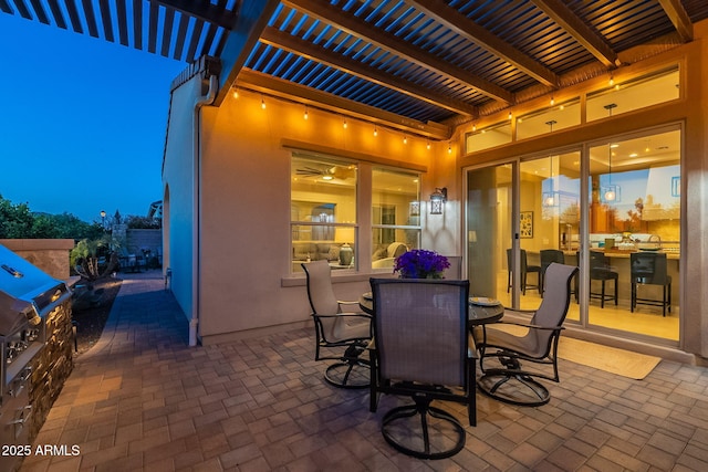 view of patio / terrace featuring outdoor dining space, an outdoor kitchen, a pergola, and grilling area