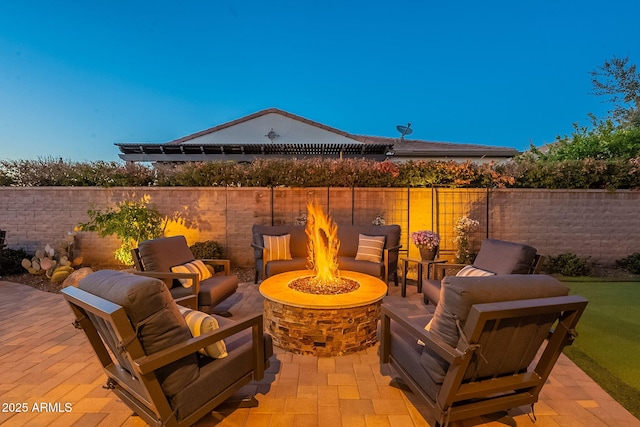 view of patio / terrace featuring an outdoor living space with a fire pit and a fenced backyard