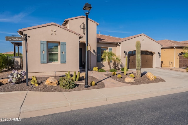 mediterranean / spanish-style house featuring a tile roof, a garage, driveway, and stucco siding