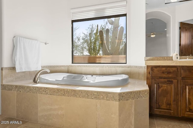 bathroom featuring plenty of natural light, a bath, vanity, and tile patterned flooring