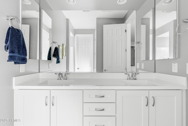 full bath with a sink and double vanity