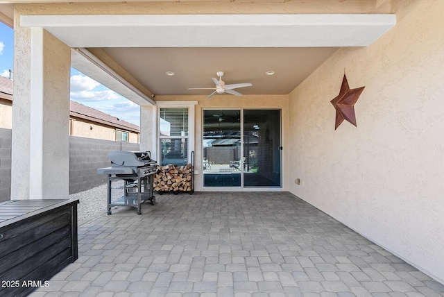 view of patio with fence, ceiling fan, and area for grilling