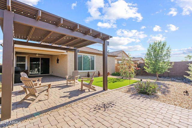 view of patio with a pergola and fence