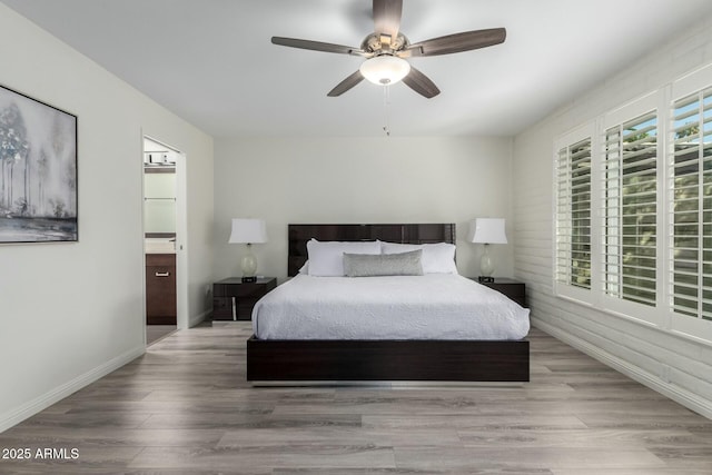 bedroom featuring ceiling fan, ensuite bath, and light hardwood / wood-style floors