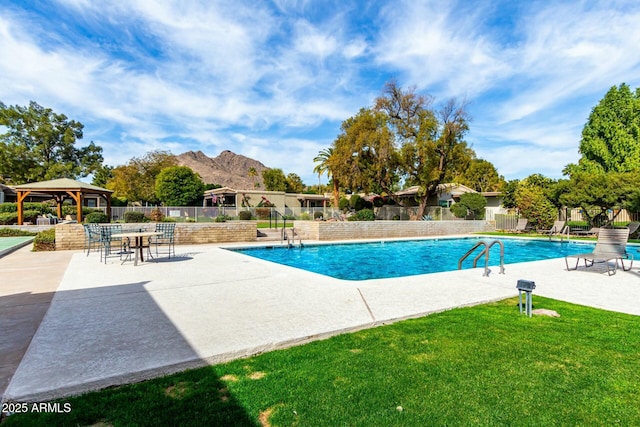 view of swimming pool with a gazebo, a mountain view, a lawn, and a patio