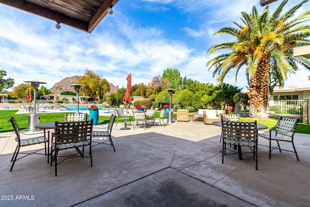 view of patio / terrace with a community pool and a mountain view