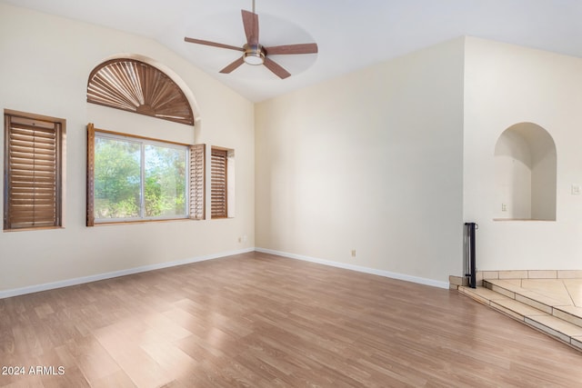 spare room featuring ceiling fan, light hardwood / wood-style flooring, and high vaulted ceiling