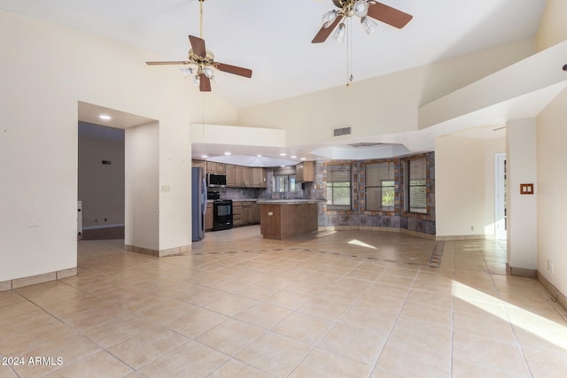 unfurnished living room featuring high vaulted ceiling, ceiling fan, and light tile patterned flooring