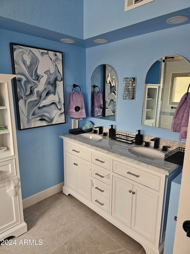 bathroom with tile patterned flooring and vanity