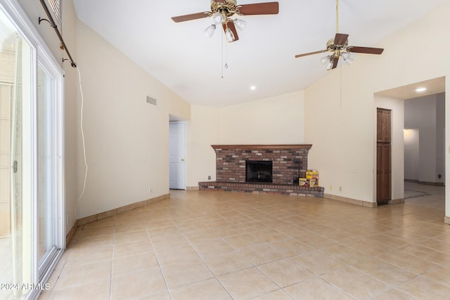 unfurnished living room with ceiling fan, light tile patterned floors, a fireplace, and high vaulted ceiling