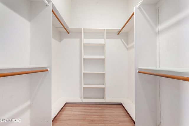 spacious closet featuring light hardwood / wood-style flooring