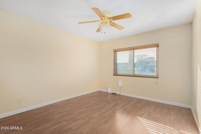 empty room with hardwood / wood-style flooring and ceiling fan