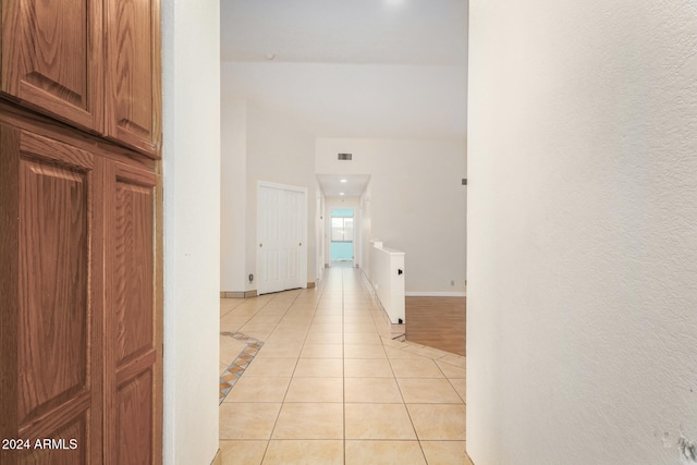 corridor featuring light tile patterned floors